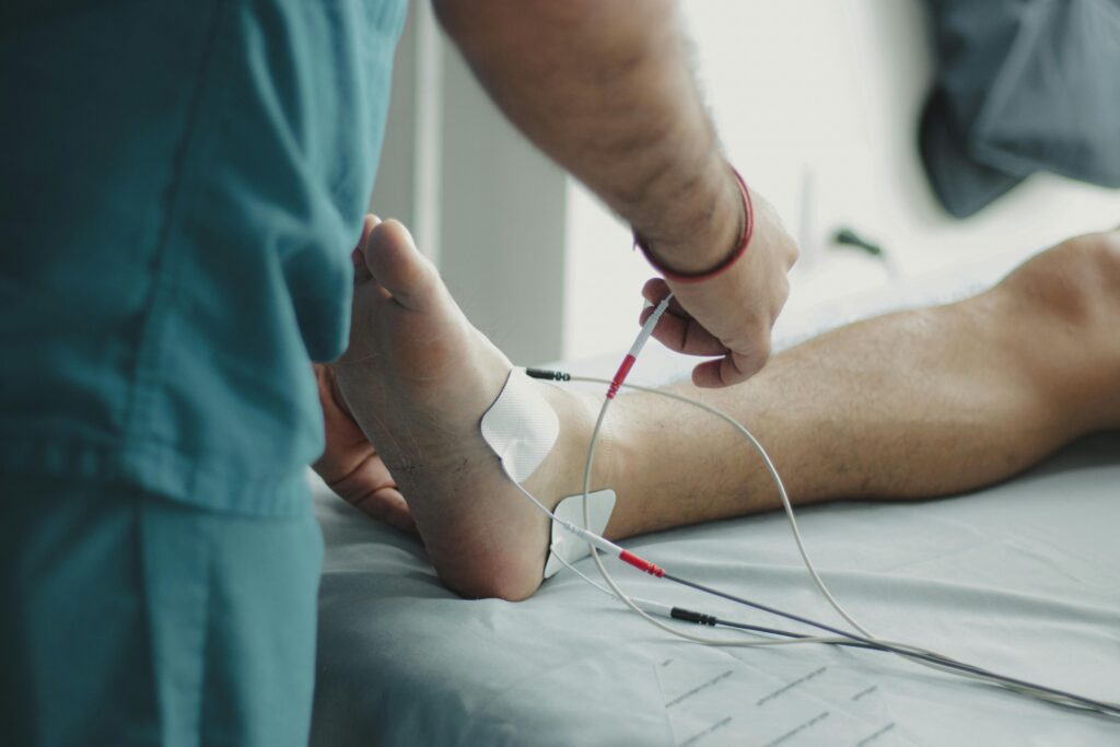 Doctor providing foot therapy treatment at a physiotherapy center in Tohana