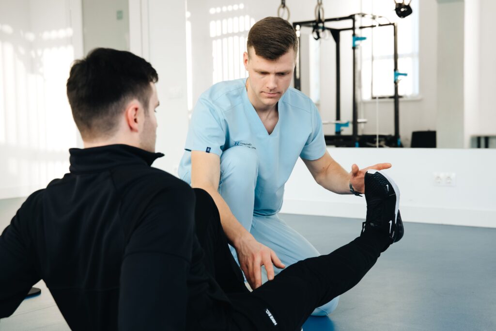 Physiotherapist demonstrating knee exercises at a physiotherapy center in Tohana