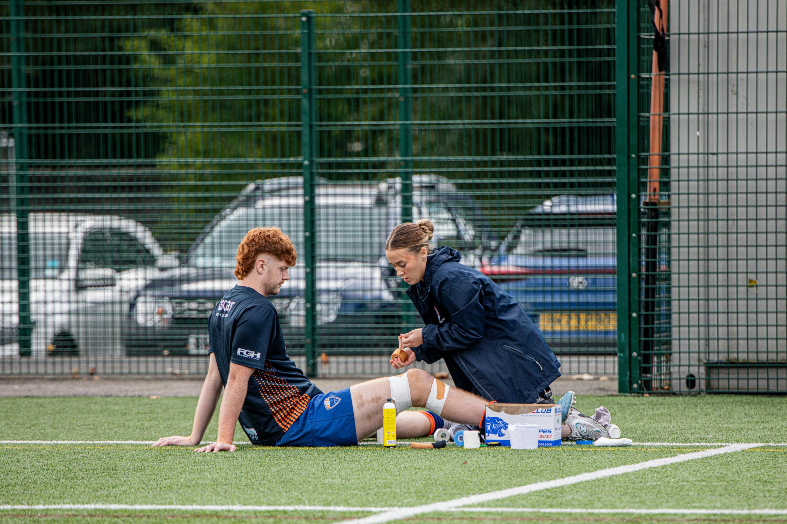 Physiotherapist providing on-field treatment for a knee injury at a physiotherapy center in Tohana