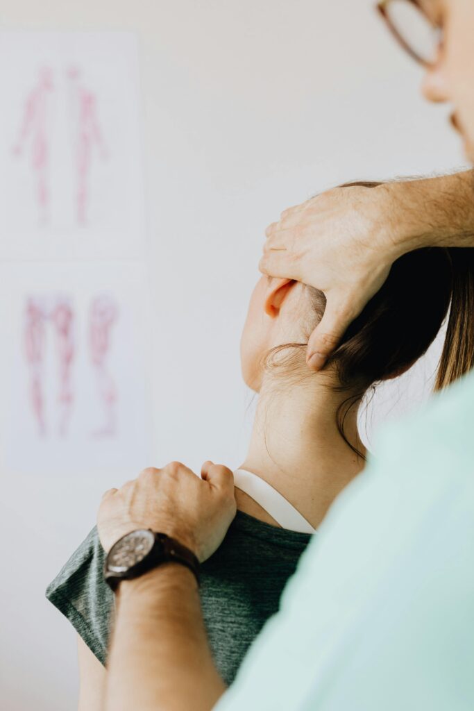Physiotherapist providing neck treatment to a patient at a physiotherapy center in Tohana