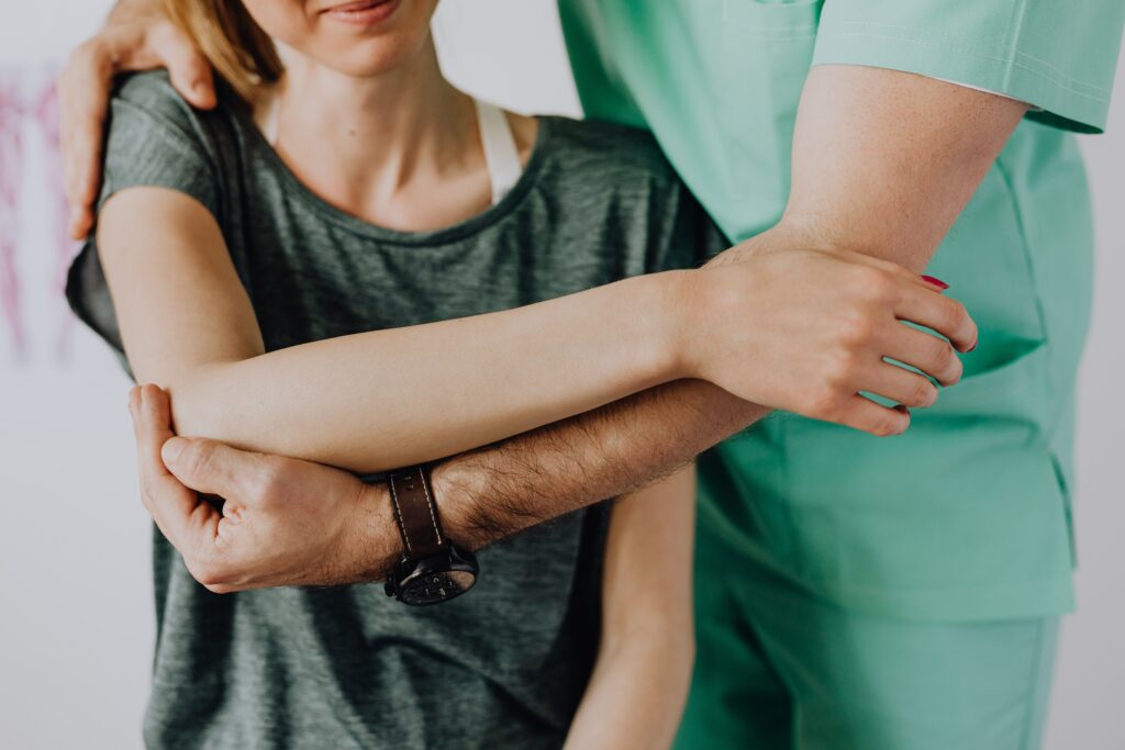 Physiotherapist treating a patient's forearm at a physiotherapy center in Tohana