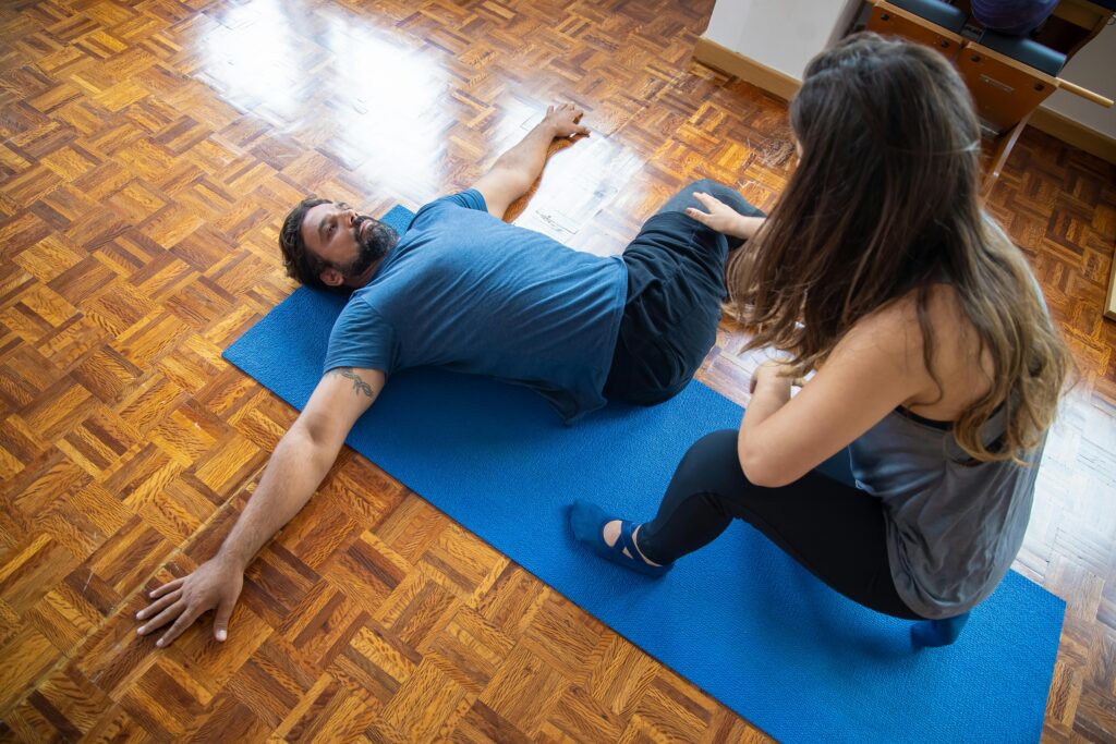 Physiotherapist providing lower back ligament rehabilitation treatment at a physiotherapy center in Tohana