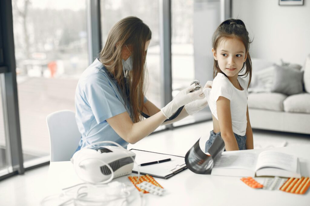 Doctor performing a pediatric checkup for a child at a physiotherapy center in Tohana